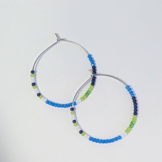 Hoop earrings with colorful beading on a white background