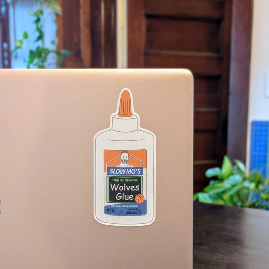Laptop with a sticker of 'Slow Mo's Wolves Glue' on a laptop.