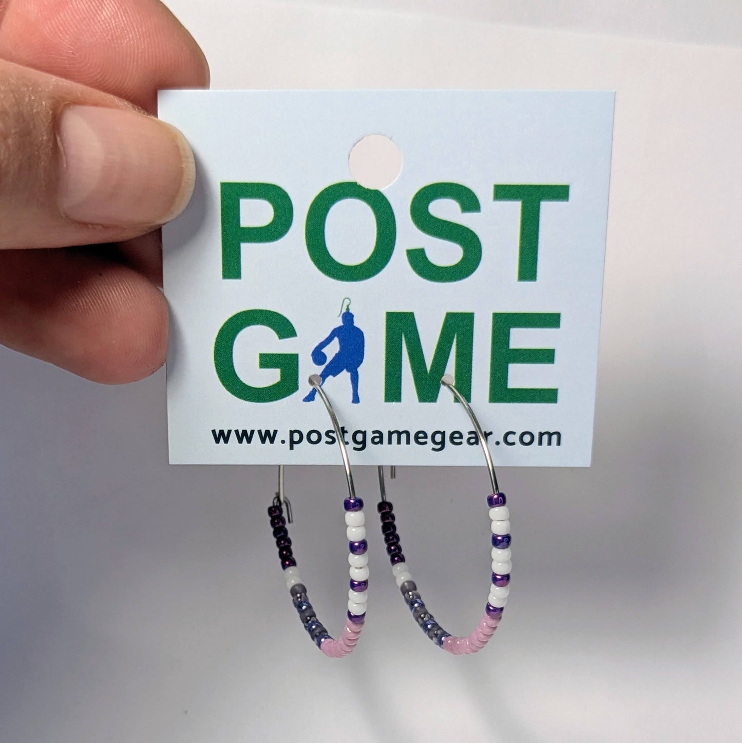 Hoop earrings with beaded accents on a 'POST GAME' branded card.