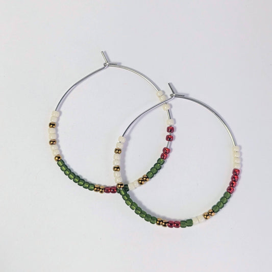 Pair of hoop earrings with beads on a light gray background