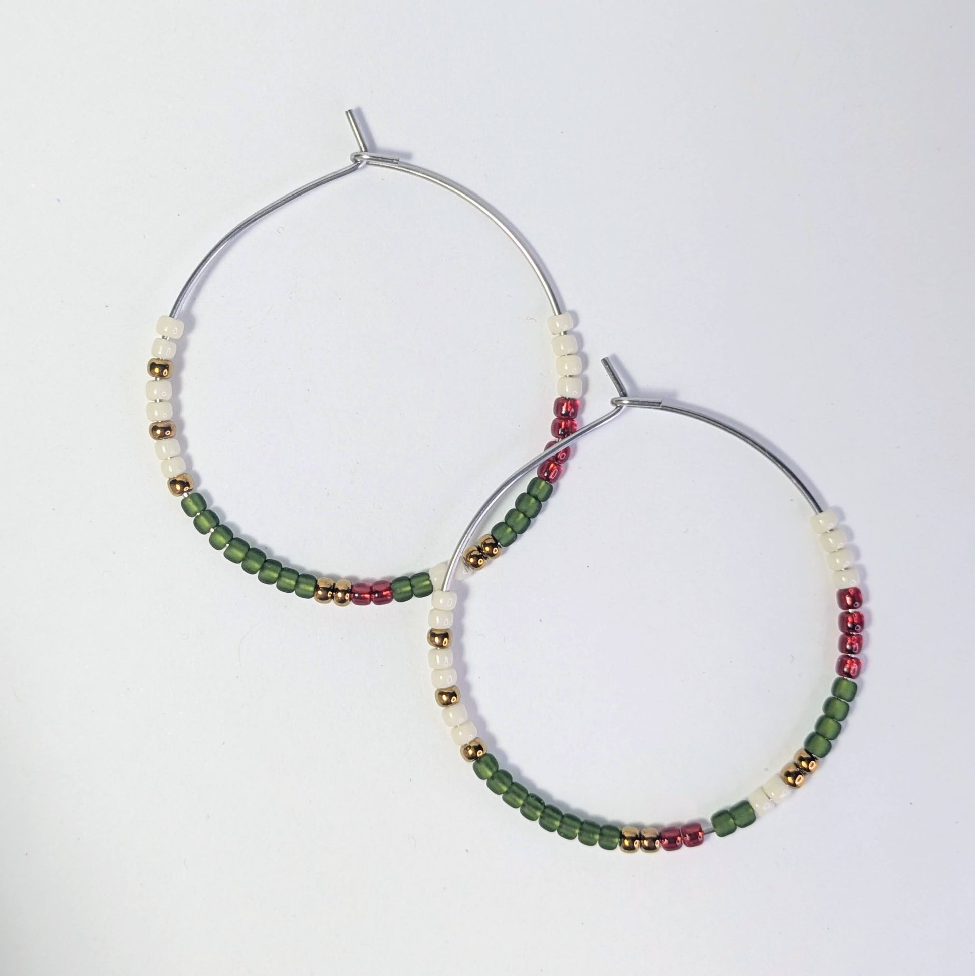 Pair of hoop earrings with colorful beads on a white background