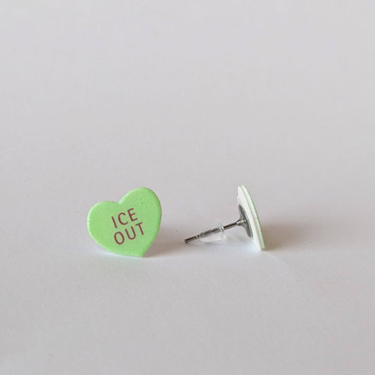 Green heart-shaped earring with 'ICE OUT' text on a light gray background