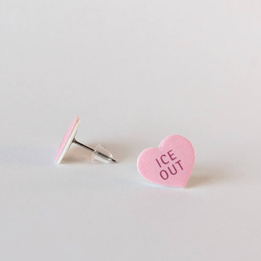 Heart-shaped pink candy with 'ICE OUT' text on a light gray background