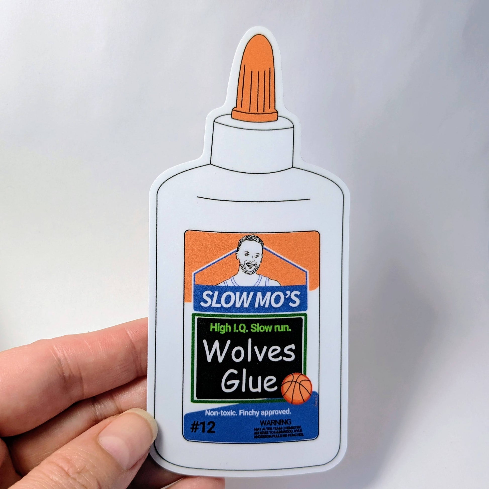 Sticker of a glue bottle labeled 'Slow Mo's Wolves Glue' held by a hand against a light gray background.