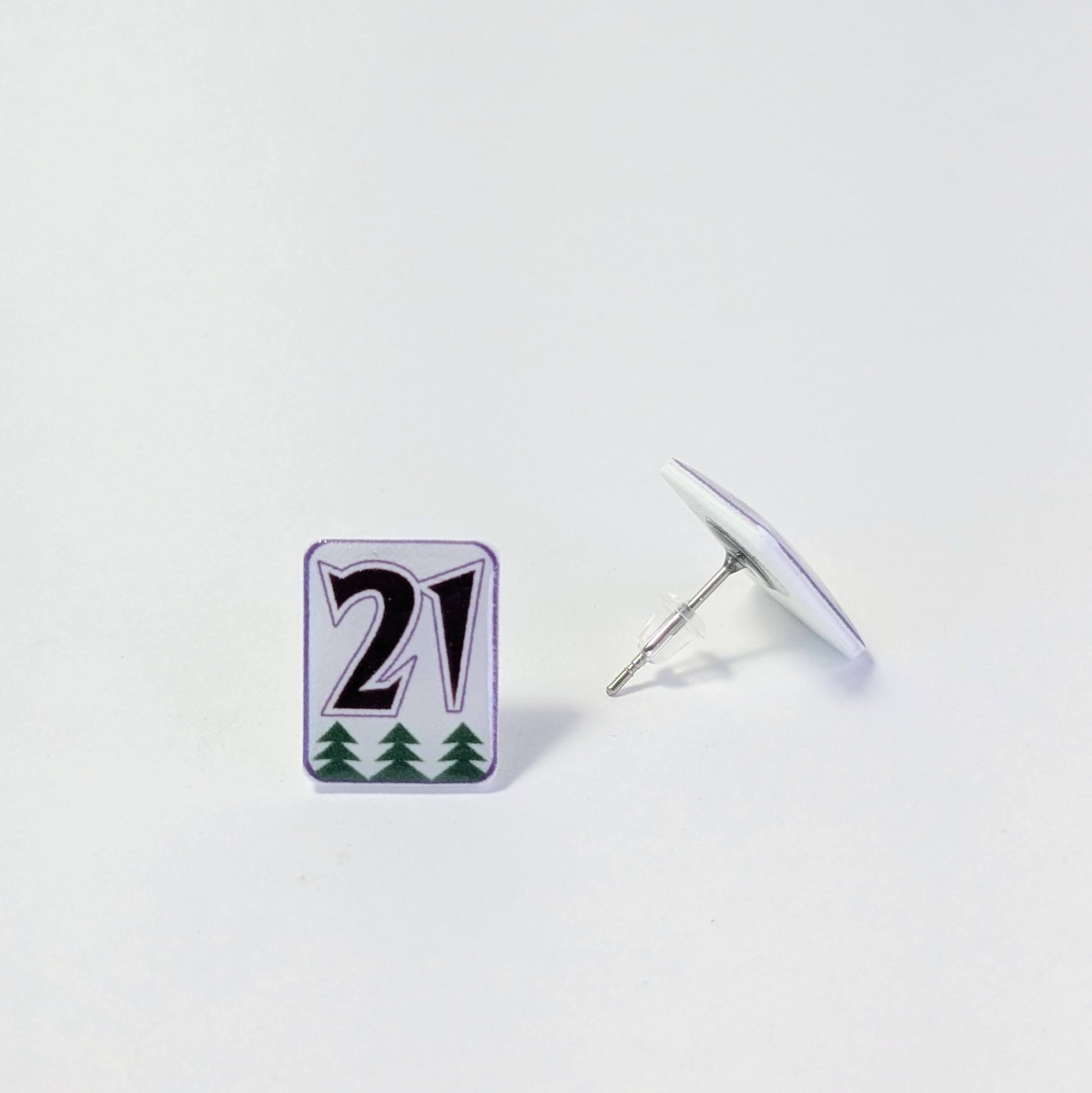 Black text on white earrings on a light gray background