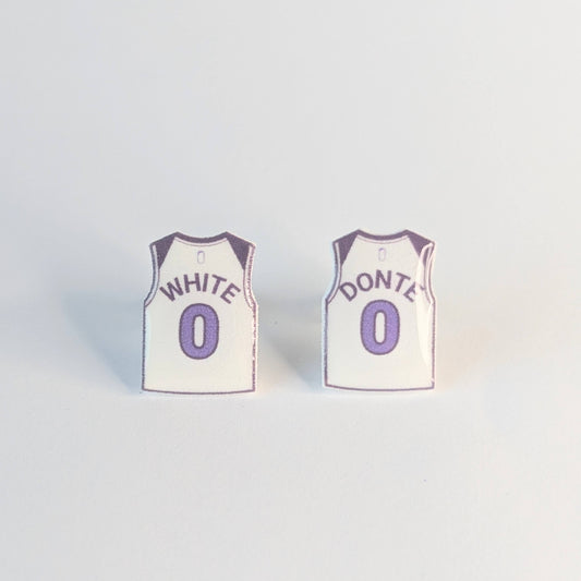 Two basketball jersey earrings with White Donte over number 0 on a light gray background,