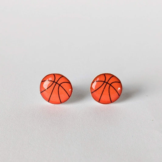 Basketball-themed earrings on a light gray background