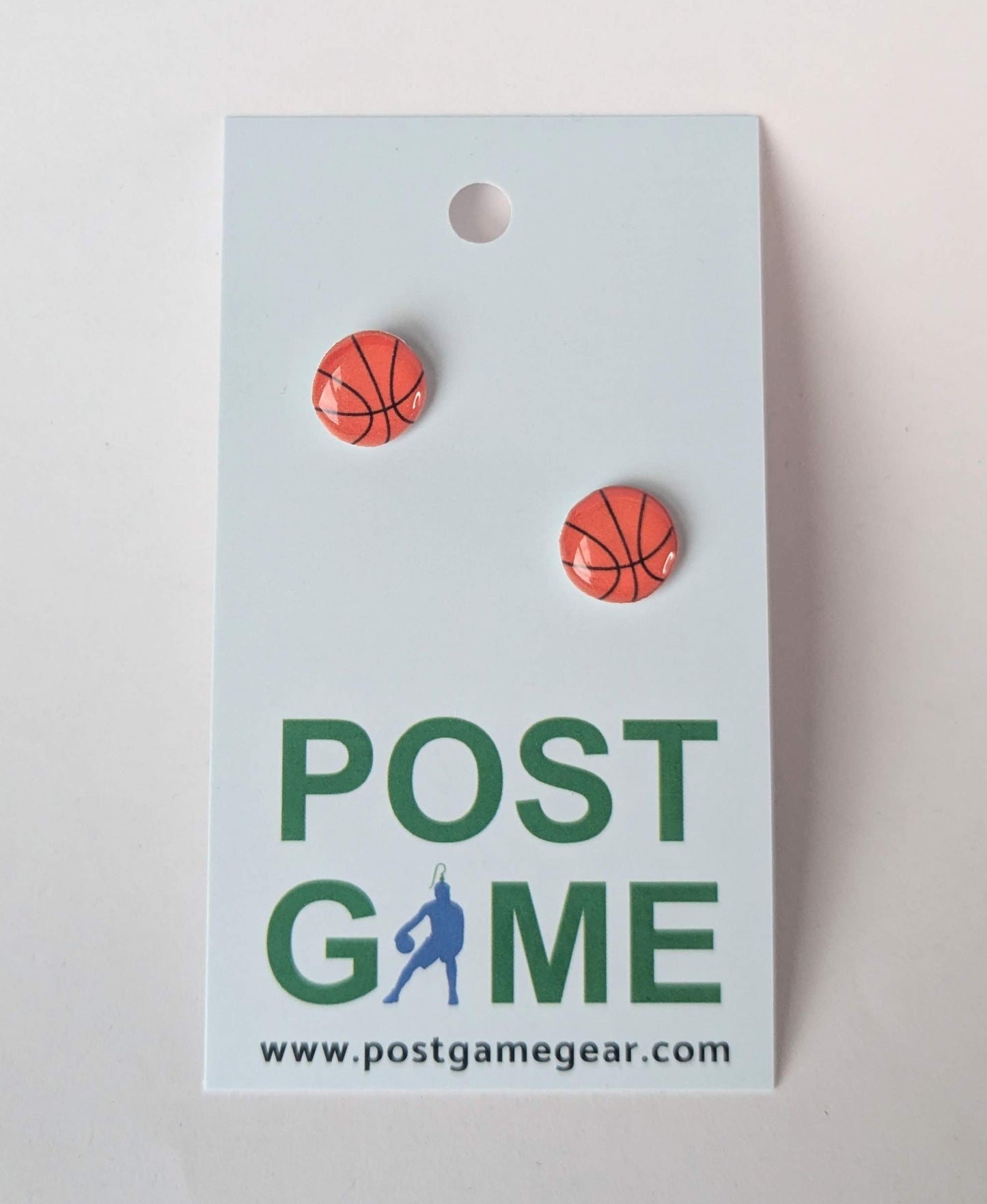 Basketball-themed earrings on a 'POST GAME' branded card with a light gray background