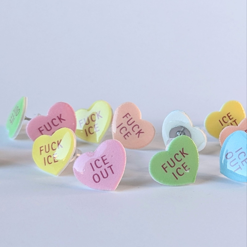Heart-shaped earrings with text, on a white background