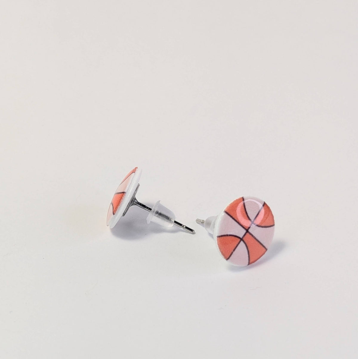 Basketball-themed stud earrings on a light gray background