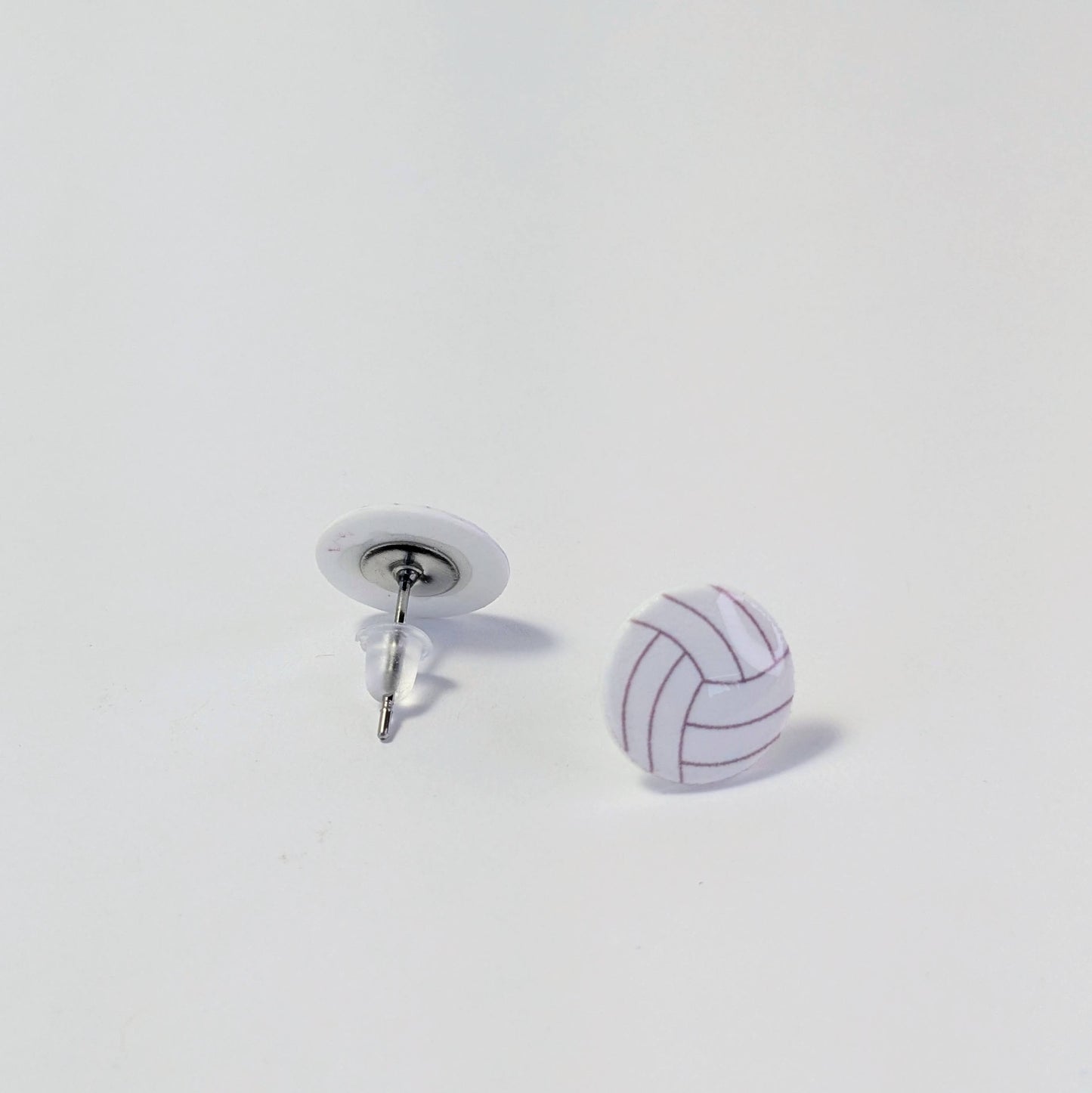 Volleyball-shaped earrings on a white background