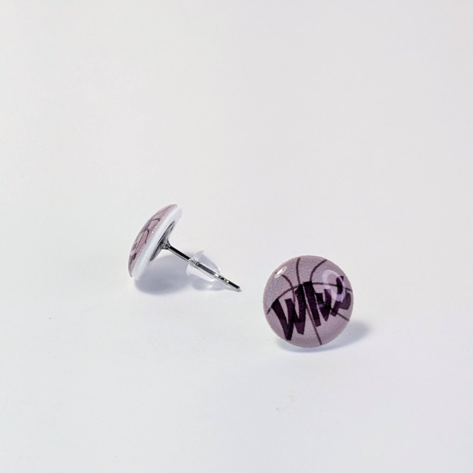 Round earrings with 'Wlvs' text on a light gray background