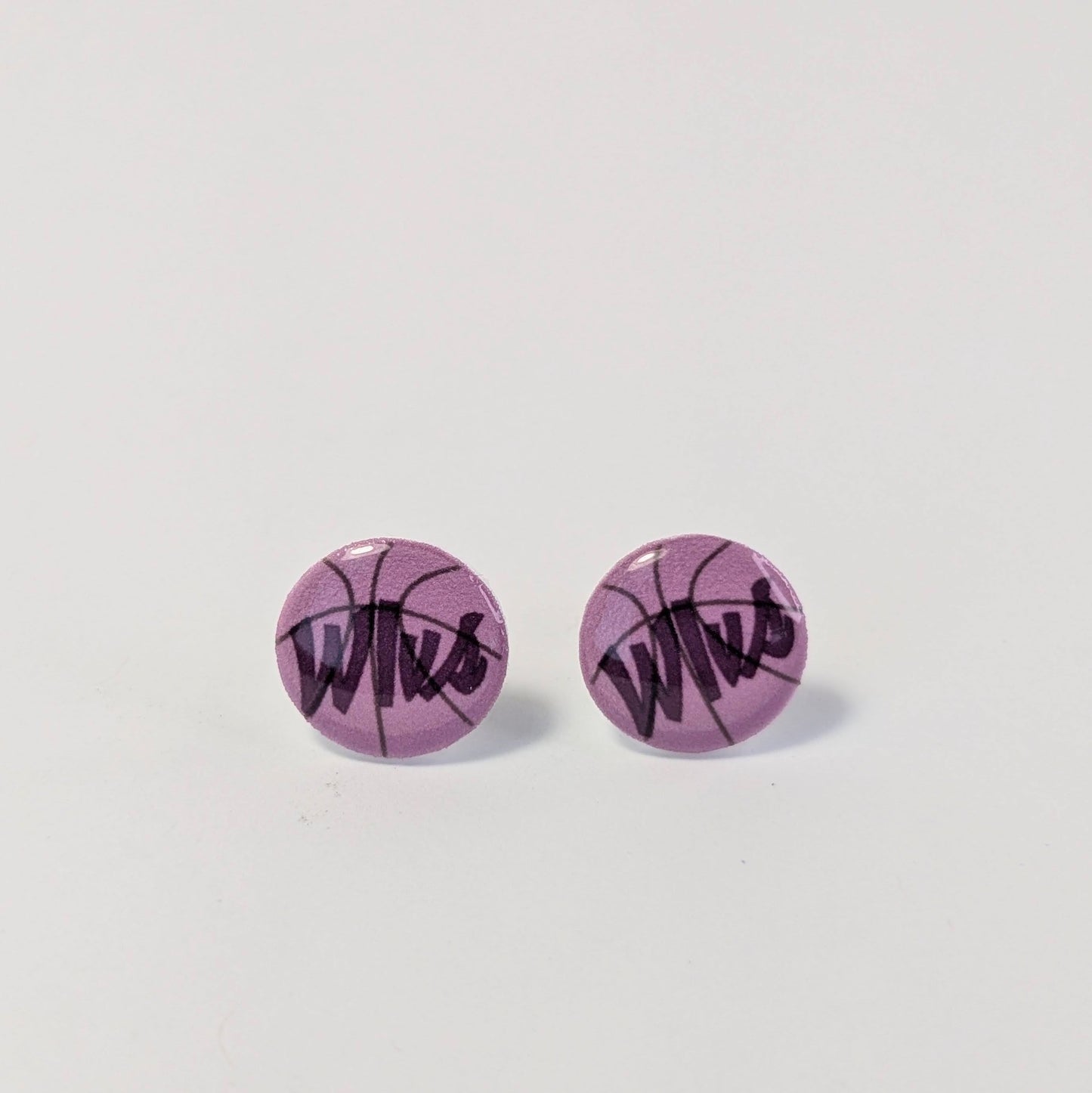Purple round earrings with black text on a light gray background