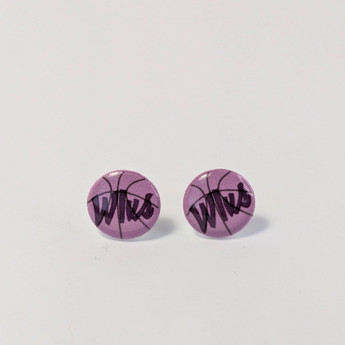 Purple round earrings with black text on a light gray background