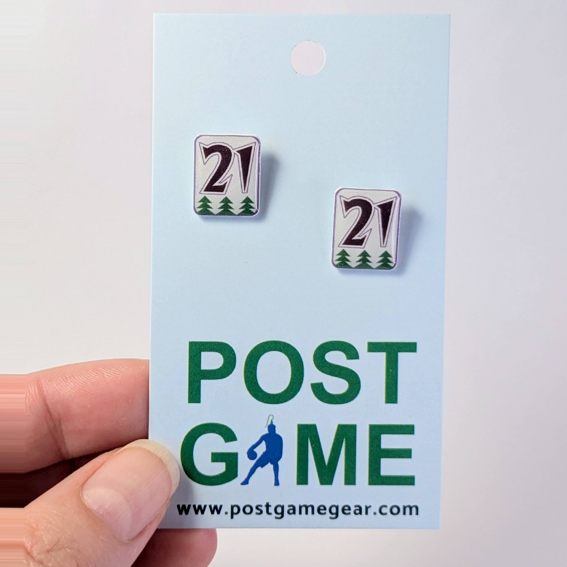 Pair of earrings with number 21 on a 'POST GAME' branded card.