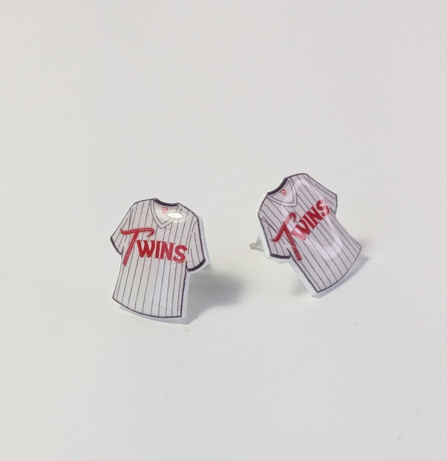 Baseball jersey earrings with 'Twins' text on a light gray background