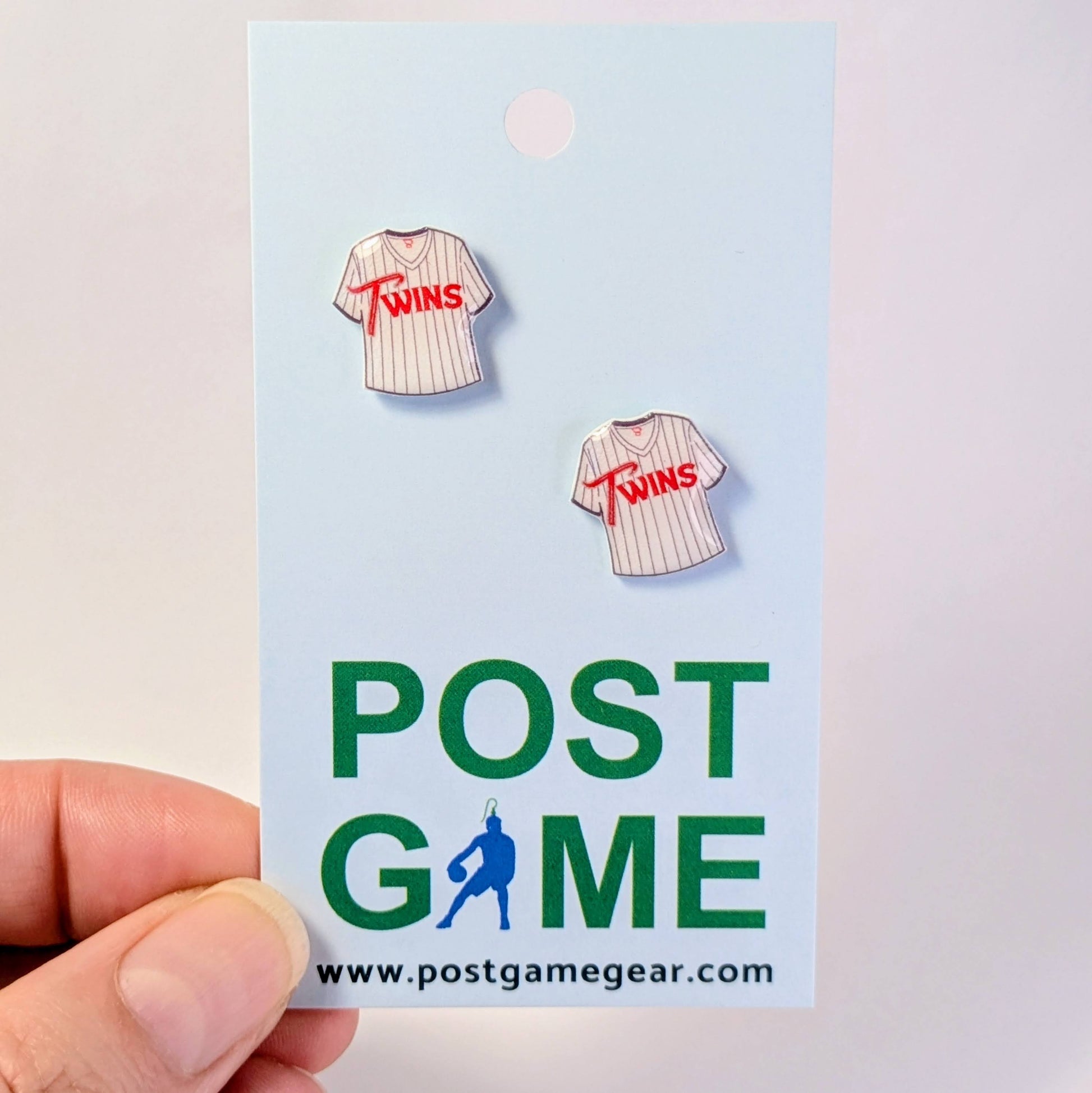 Earring set shaped like a baseball jersey with 'Twins' text on a 'POST GAME' card.