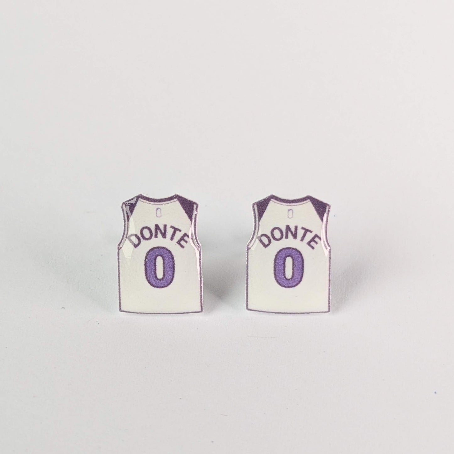 Two miniature basketball jersey earrings with 'Donte' and number '0' on a light gray background