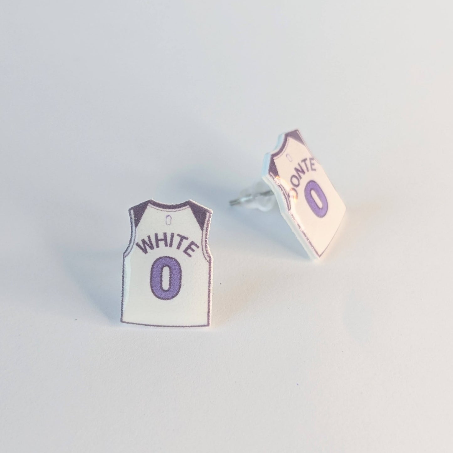 Basketball jersey earrings with 'White'  and 'Donte' over number '0' on a light gray background.