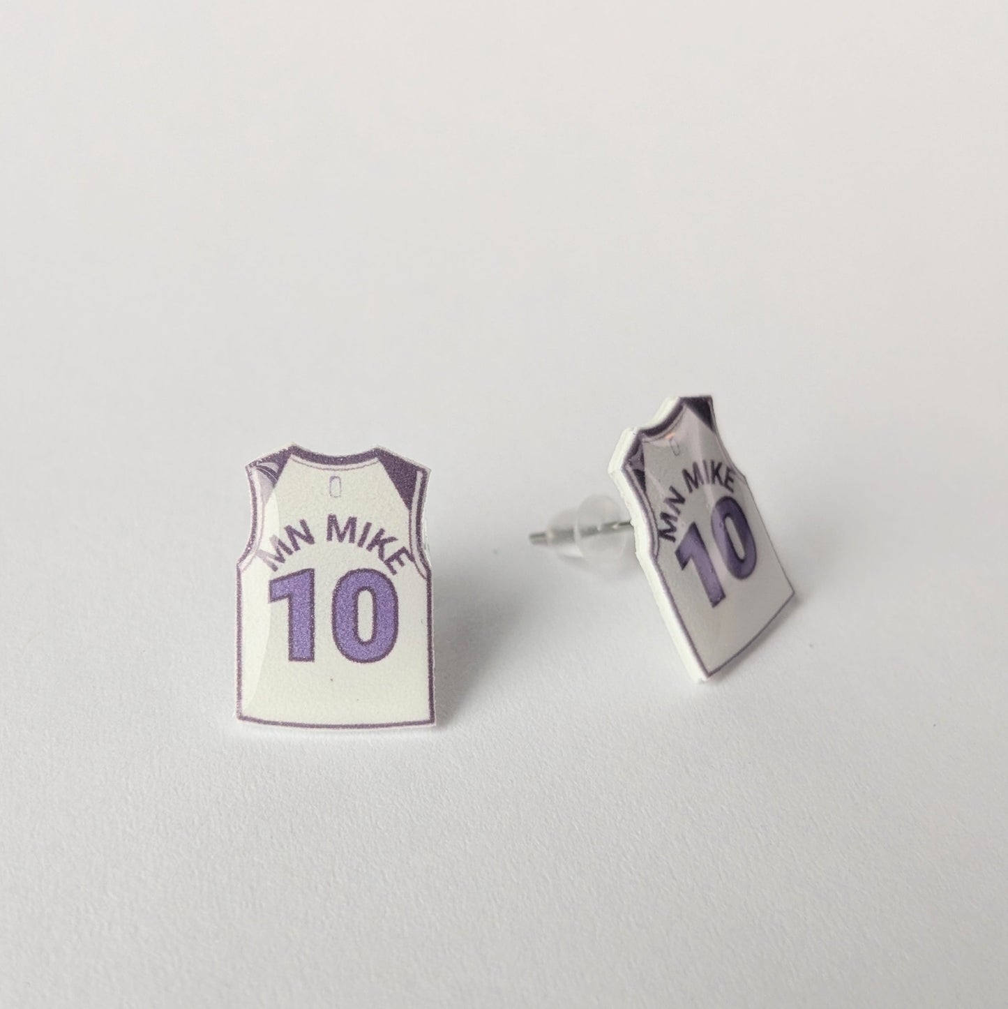 Basketball jersey earrings on a light gray background