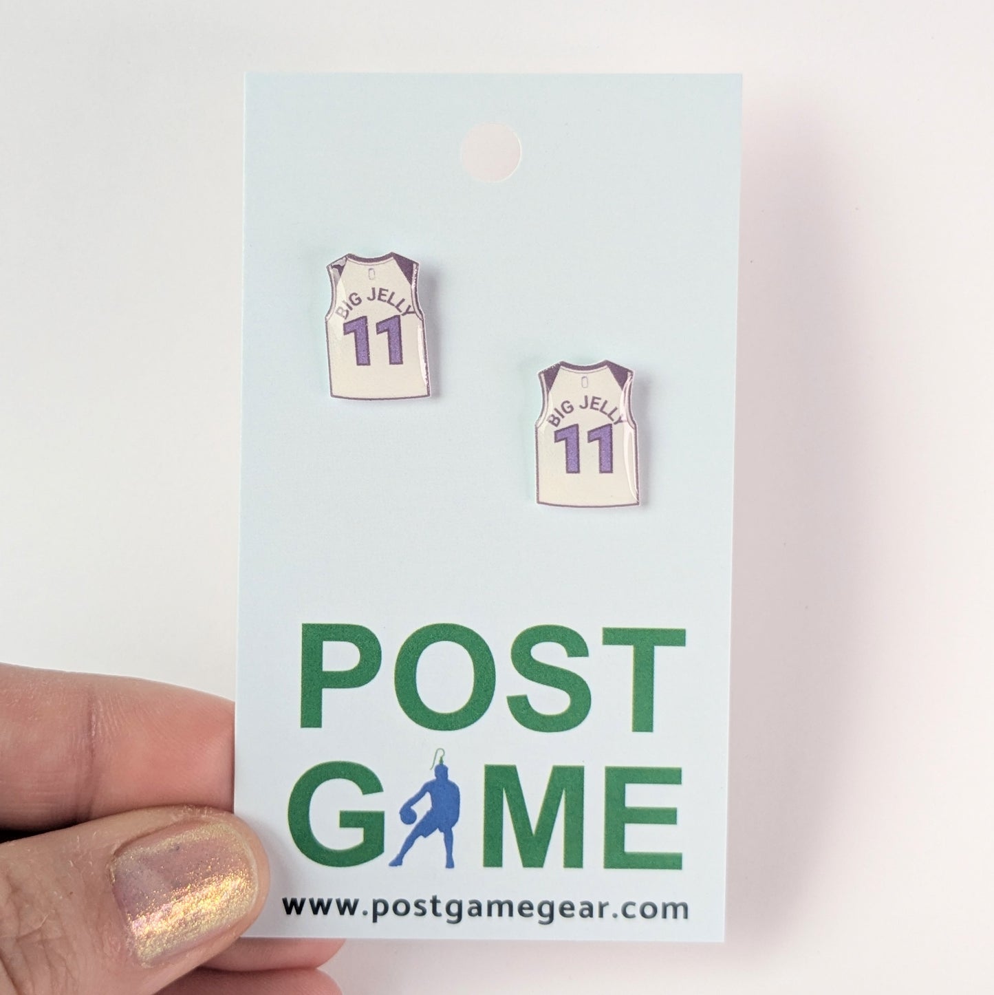 Basketball jersey earrings on a 'POST GAME' card with website URL.