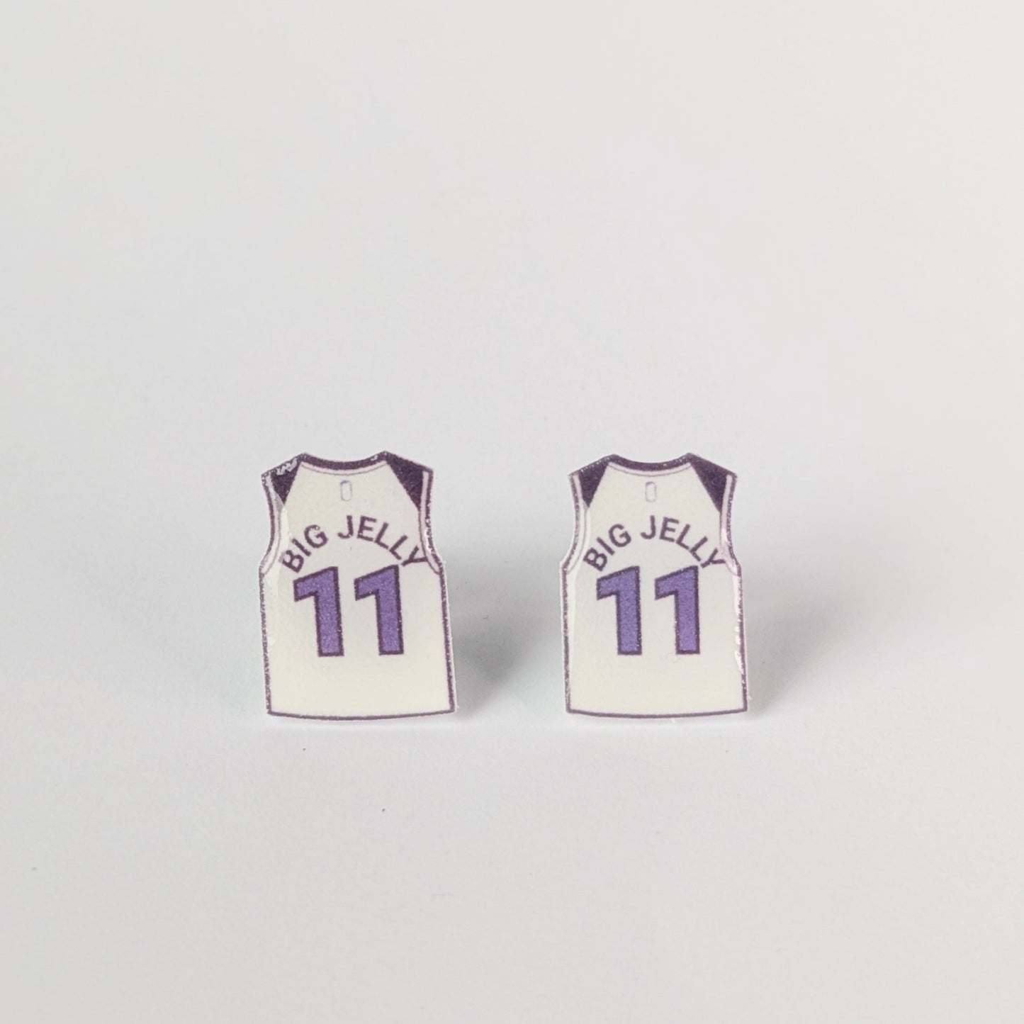 Two basketball jersey earrings with 'BIG JELLY' and number '11' on a light gray background