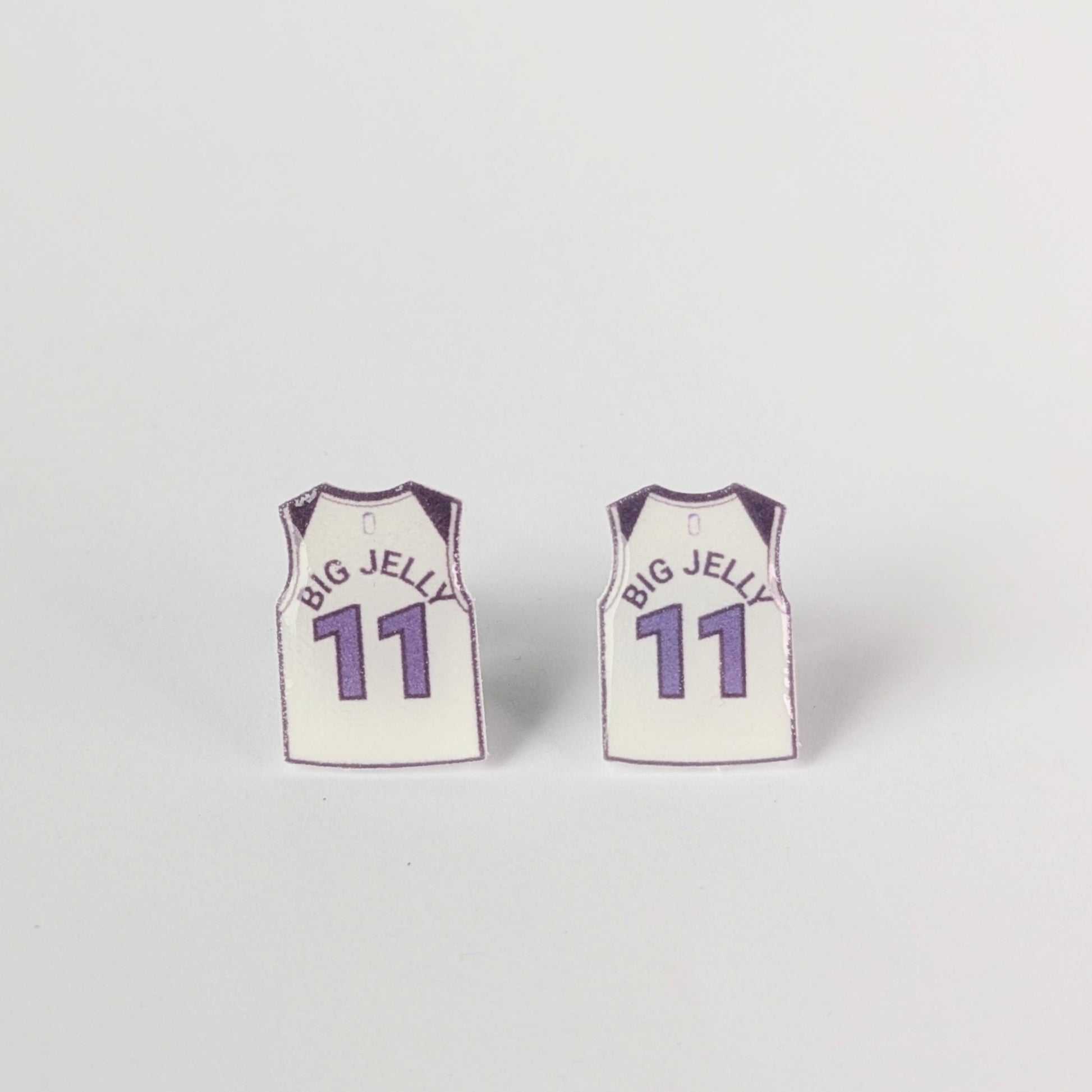 Two basketball jersey earrings with 'BIG JELLY' and number '11' on a light gray background