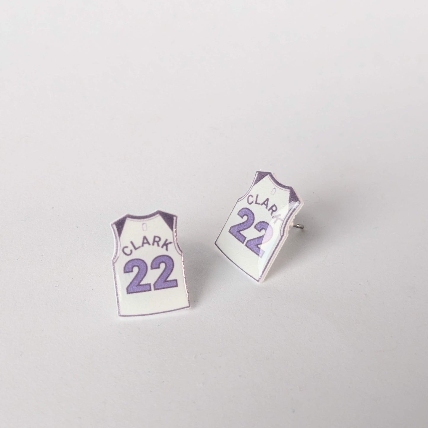 Pair of earrings shaped like miniature sports jerseys with 'Clark' and number '22' on a light gray background.