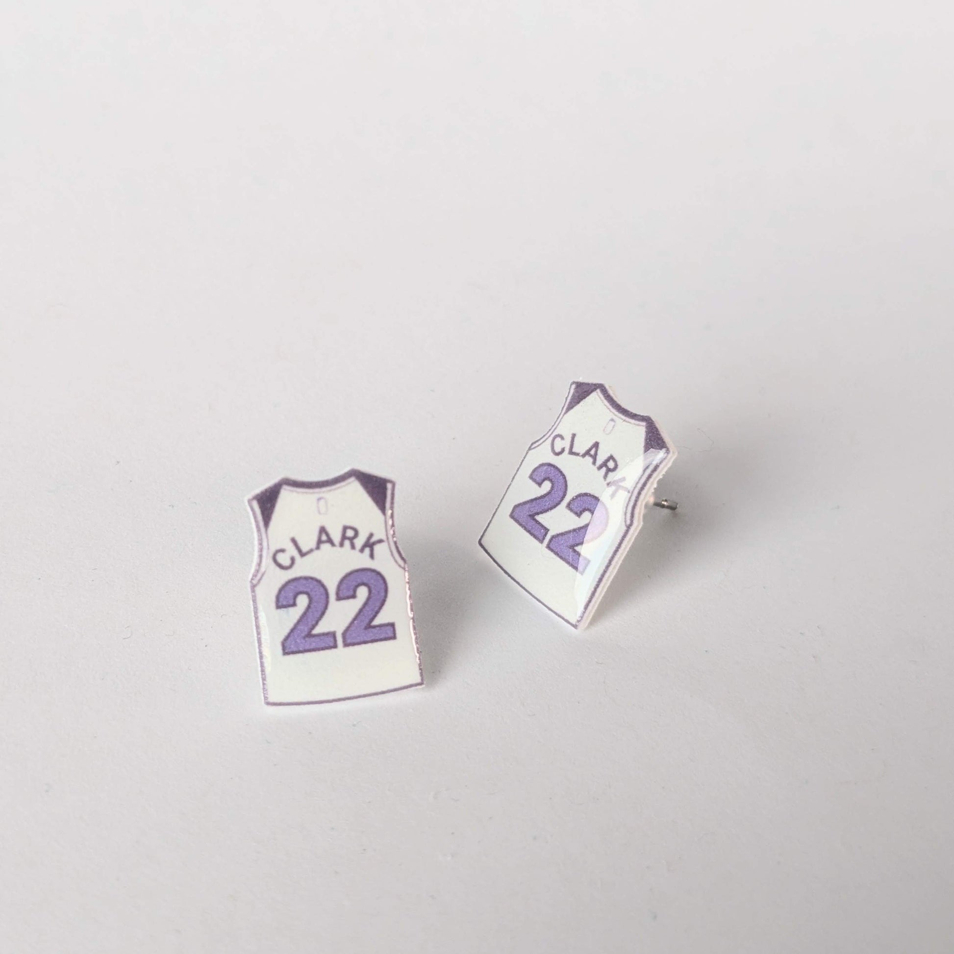 Pair of earrings shaped like miniature sports jerseys with 'Clark' and number '22' on a light gray background.