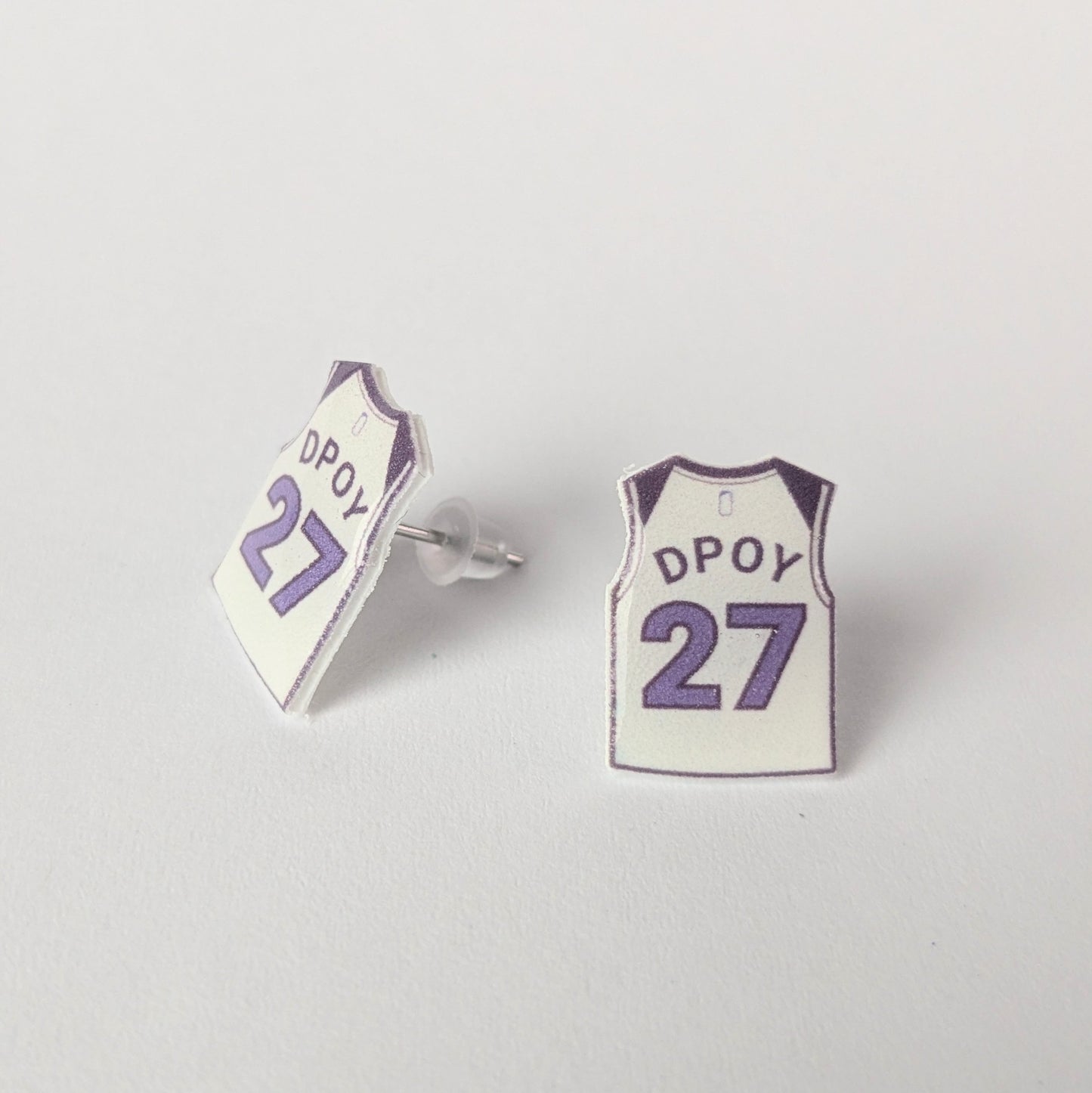 Basketball jersey earrings with 'DPOY' and number '27' on a light gray background