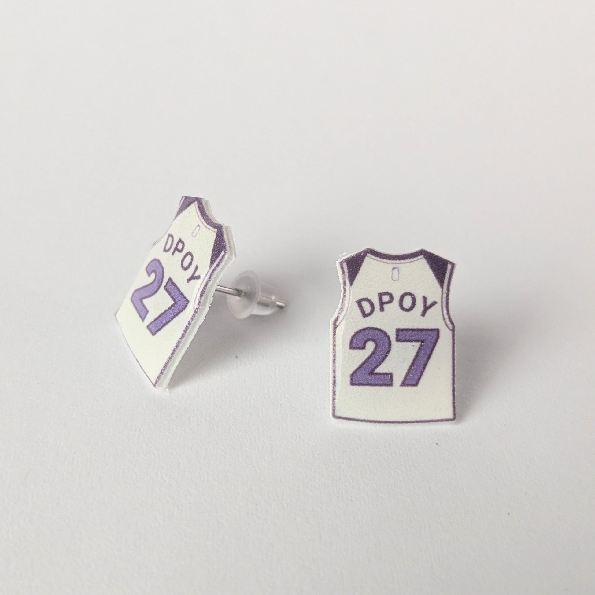 Basketball jersey earrings with 'DPOY' and number '27' on a light gray background