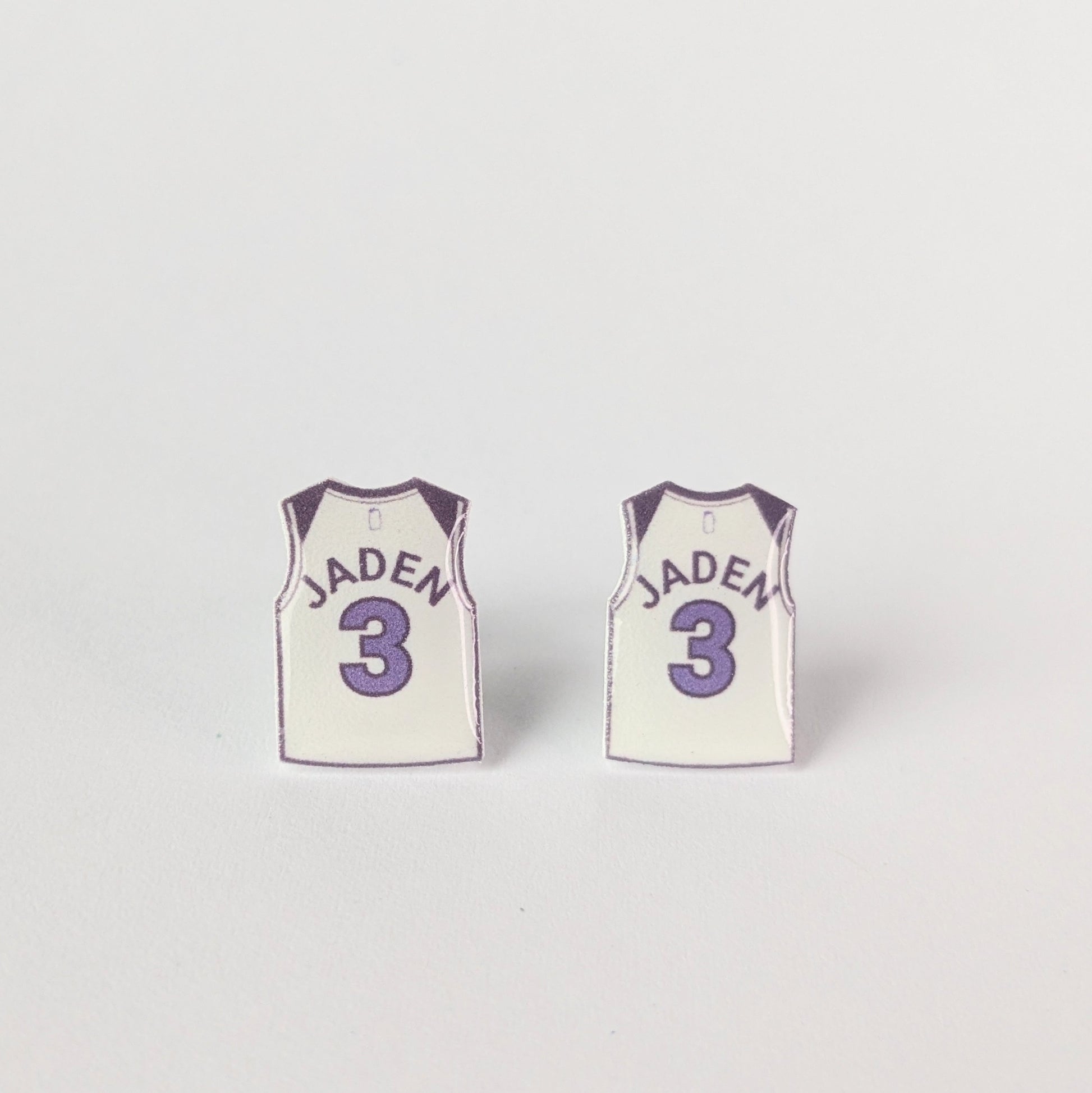 Two small basketball jerseys with 'Jaden' and number '3' on a light gray background