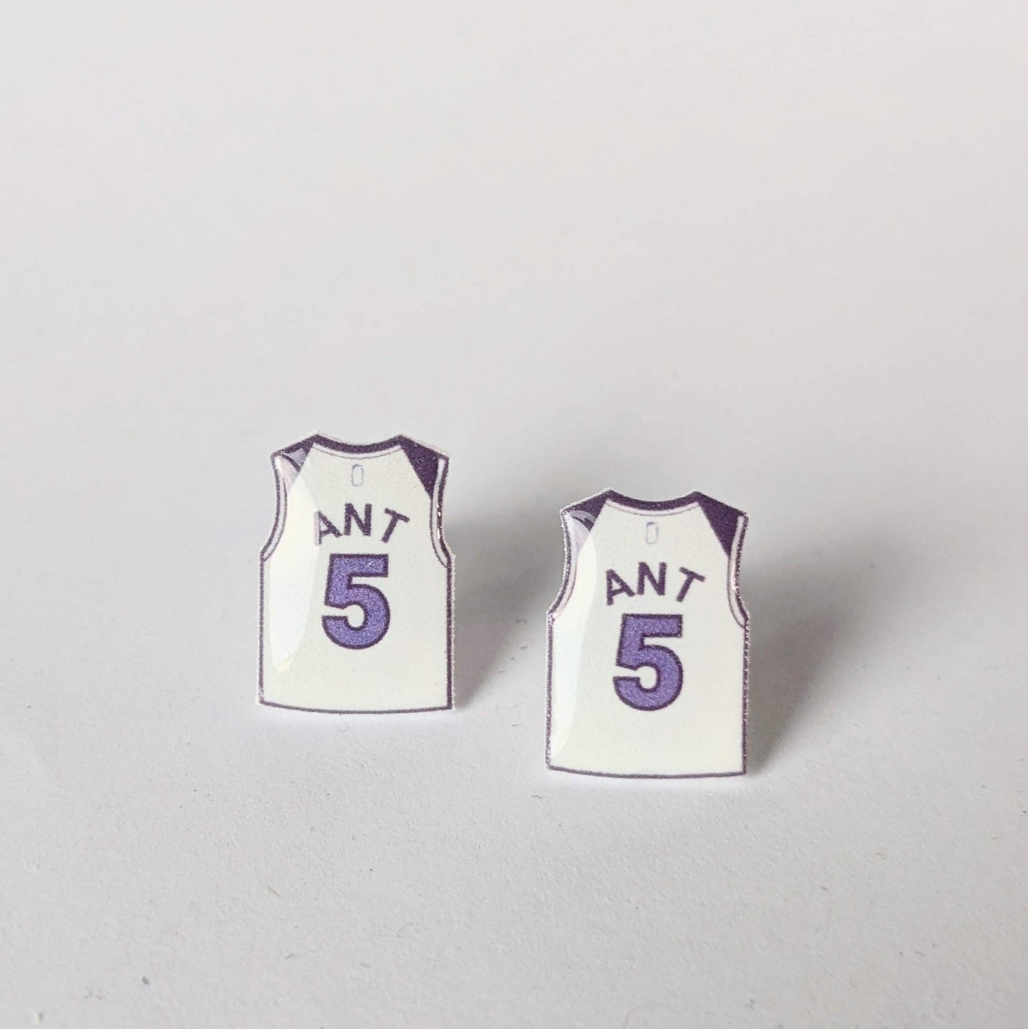 Two miniature basketball jersey earrings with the number 5 and the name 'ANT' on a light gray background.