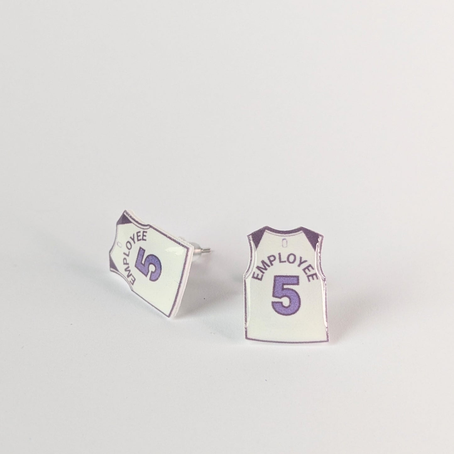 Pair of earrings shaped like miniature sports jerseys with 'Employee 5' text on a light gray background