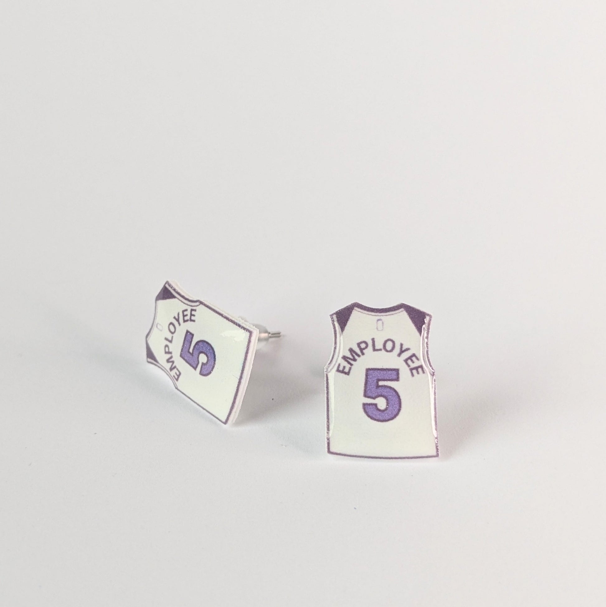 Pair of earrings shaped like miniature sports jerseys with 'Employee 5' text on a light gray background