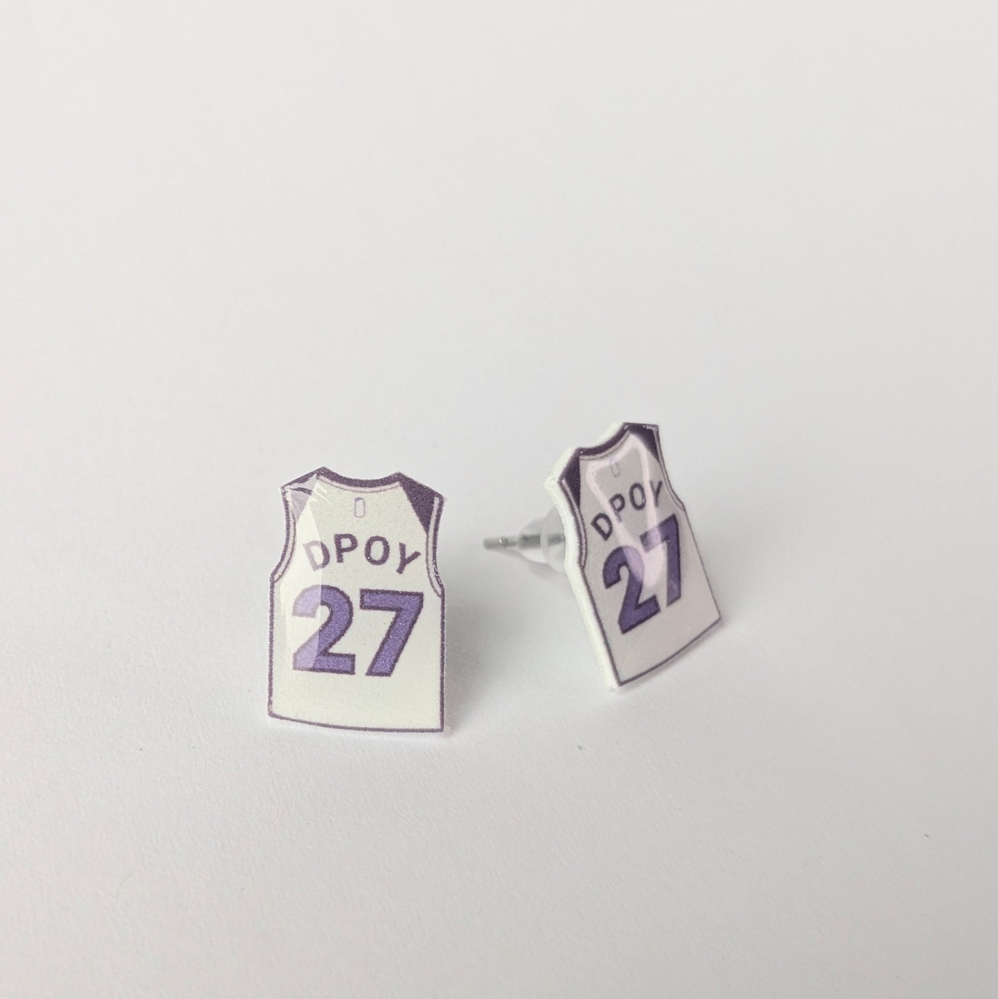 Basketball jersey earrings with 'DPOY 27' on a light gray background